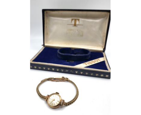 A Tissot 9ct gold ladies watch on an articulated bracelet and safety chain in the original presentation box.&nbsp;11.1 gram