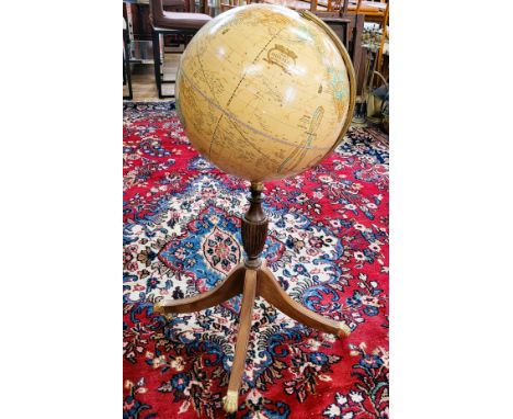 A vintage Cram's Imperial world globe with meridian ring on a turned baluster support, with four out swept legs on brass claw