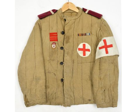 An unusual WWII Russian Medical Orderley’s quilted combat jacket, black composition buttons, red cross brassard and breast pa