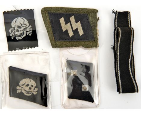 A Third Reich Bevo weave Deaths head, an SS collar patch on a portion of field grey collar; a collar patch with 2 NCO pips an