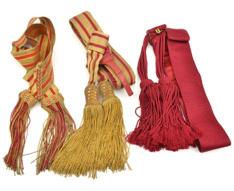 A crimson and gilt bullion waistsash with large fringed tassels; another similar Vic officer’s shoulder sash and a plain crim