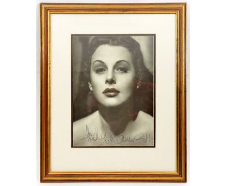 A close up head and shoulders studio photographic portrait signed “Hedi Lemaar”, well mounted and framed in gilt, 17” x 14” V