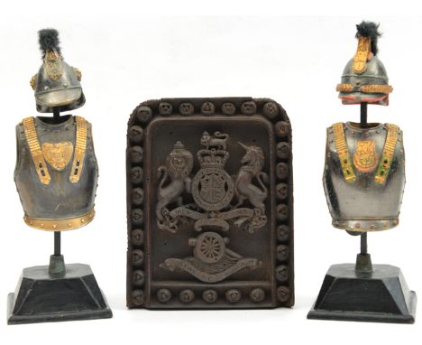 A small carved Indian darkwood panel,  Vic R Arms/ cannon/ RA motto in frame of florets, 6½” x 5½”; a pair of desk weights/or