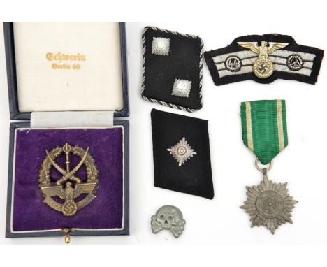 A Third Reich die struck Cossack badge;  an Eastern Peoples award 2nd class with swords; SS collar patch with 2 pips and brai