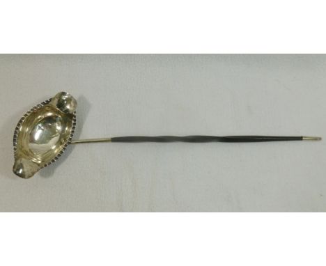 An 18th century silver double lipped toddy ladle with crimped edge and whale bone handle, 35.5cm long CONDITION REPORT: Some 