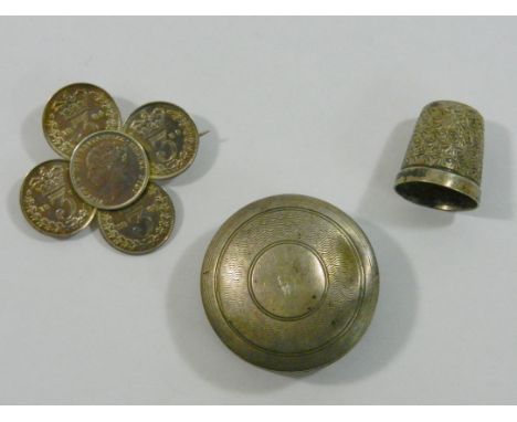 A small circular silver box, Birmingham 1913 by George Unite, with engine turned decoration, a Sterling silver thimble, size 