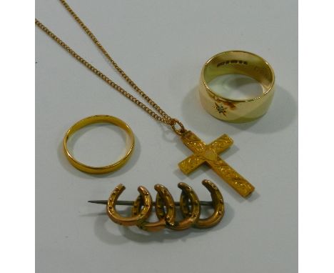 An Edwardian 9 carat gold cross pendant with chased decoration, Birmingham 1909, and chain, a 9 carat gold horseshoe bar broo