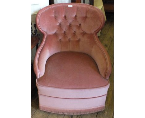 A modern pink draylon upholstered button back armchair
