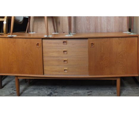 A Danish long sideboard with two sliding doors and four drawers on tapered legs