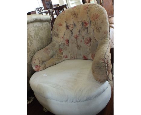 A green upholstered armchair and a button back tub chair