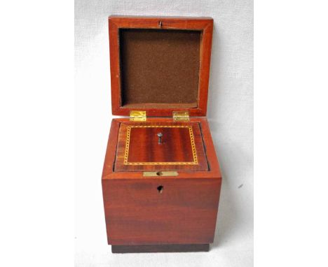 A mahogany and walnut Tea Caddy of cube form, the inlaid hinged cover opens to reveal an inlaid inner cover and foil lined in