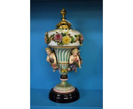 A late 19th/early 20th century Dresden style Table Centrepiece of urnular form, gilt highlighted porcelain encrusted with ros