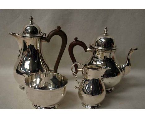 A George V silver four-piece Tea Service of compressed circular form comprising, teapot and water jug with hinged covers and 