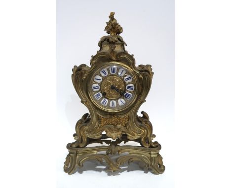 A French gilt metal clock of rococo style, the dial with white and blue enamel roman numeral plaques, the movement marked Car