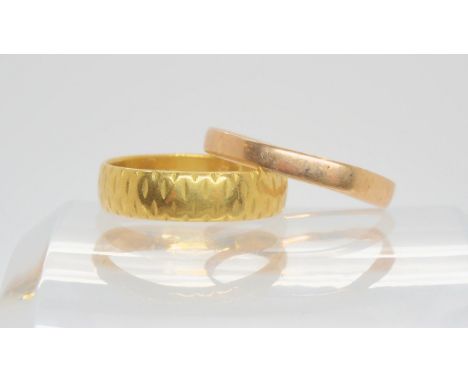 A 22ct gold wedding ring, size O, weight 4.1gms, and a 9ct example, size R1/2, weight 1gms Condition Report:Available upon re