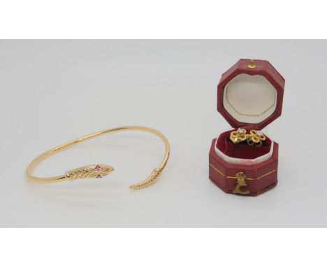 A 9ct gold snake bangle with ruby eyes, together with a pair of shamrock diamond set ear studs, weight 6.6gms Condition Repor