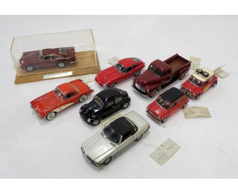 A small collection of Franklin Mint scale model vehicles, including an Aston Martin DB5 in Perspex display case, Jaguar E-Typ