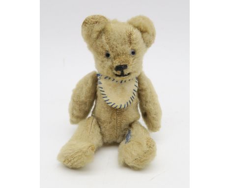 A miniature teddy bear by Chad Valley, with articulated limbs, standing approx. 12.5cm in height. Included with the lot is a 