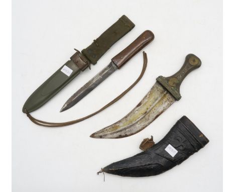 A kukri, the grip with white metal wirework detail; together with an unmarked knife housed in a US M8A1 scabbard (2) Conditio