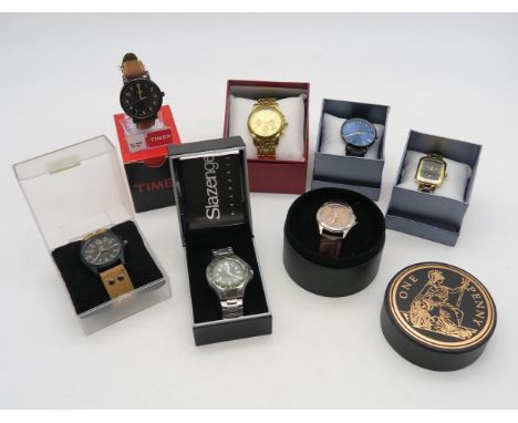 Seven boxed fashion wristwatches, to include Timex, Slazenger, Soki, a "Penny Watch" etc. Condition Report:Available upon req