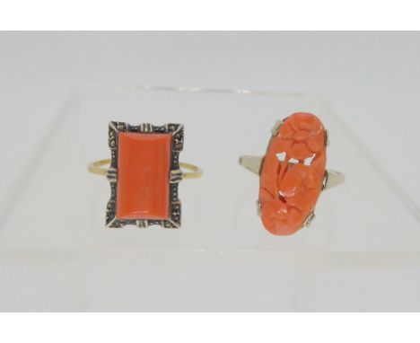 A white metal mounted flower carved coral ring, size N1/2, together with a 9ct gold and white metal mounted coral ring, size 