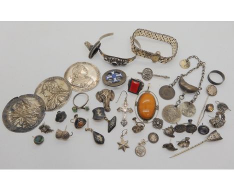 A collection of silver and white metal items to include an amethyst bangle, Arabic coin jewellery, a German silver Hitler lap