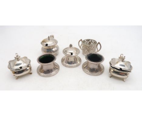 A collection of silver salts / preserve pots, including a set including a preserve pot with shell thumbpiece, a pair of open 