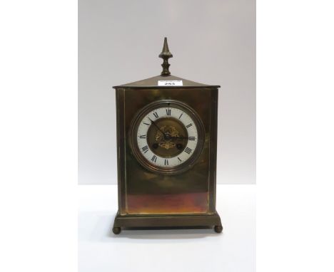 A French brass mantle clock, the dial with enamelled chapter ring with roman numerals, the movement stamped Marti and with nu