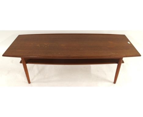 A mid 20th century teak coffee table in the manner of Edvard Kindt Larsen with turned tapering supports connected by lower ti