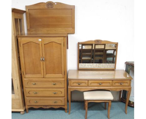 A 20th century light oak bedroom suite comprising armoire, 148cm high x 83cm wide x 45cm deep, mirror backed dressing table, 