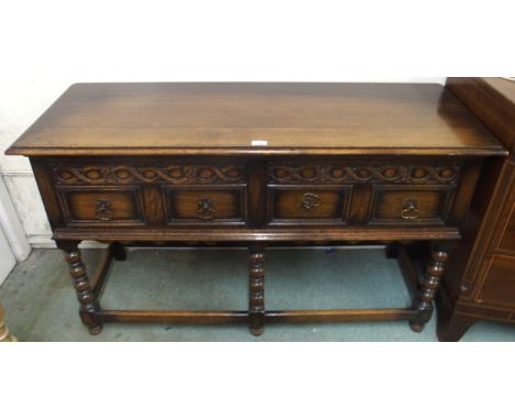 A 20th century oak baronial style two drawer buffet table on stretchered bobbin turned supports, 80cm high x 130cm wide x 47c