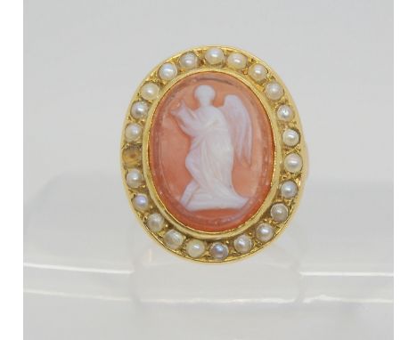 An agate angel cameo ring, mounted in yellow metal, and further set with pearls. Dimension of the cameo 16mm x 12mm, carved w
