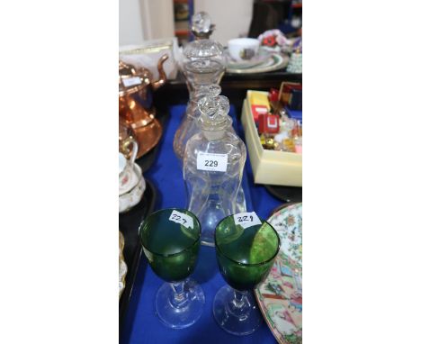 A silver mounted hour glass decanter, another hour glass decanter, a three ring decanter and a pair of green glass drinking g