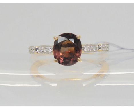 An 18ct gold GemsTV colour change garnet and diamond ring, designed by Thomas Rae, finger size N1/2, weight 3gms, with Gempor