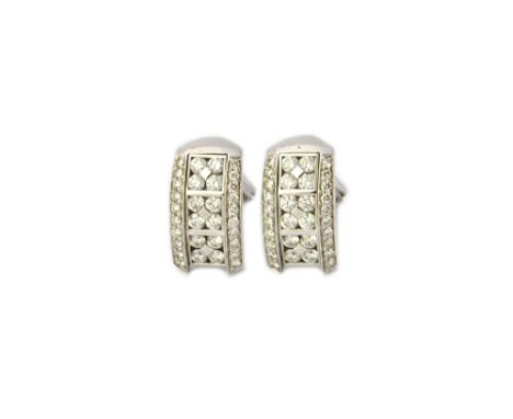 A pair of white gold and diamond set earclips by Picchiotti, each of curved rectangular form, mounted with three clusters of 