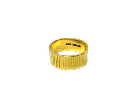 An 18ct gold wide band wedding ring, with ribbed decoration, London 1961, ring size O, weight 7 gms.