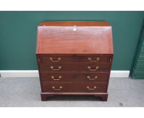 A George III mahogany bureau with fitted interior over four long graduated drawers, on bracket feet, 97cm wide. 