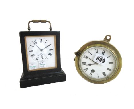 A brass cased ships style wall clock, early 20th century, the circular drum case with white enamel dial enclosing a single tr