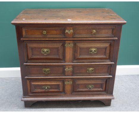 A Charles II oak chest of four long graduated geometric drawers, on bracket feet, 99cm wide x 95cm high.