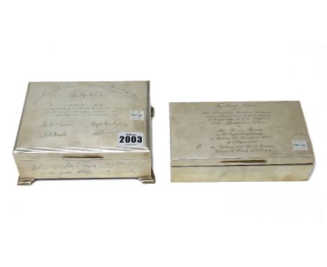 A silver rectangular hinge lidded cigar box, presentation inscribed and engraved with facsimile signatures, raised on four fe