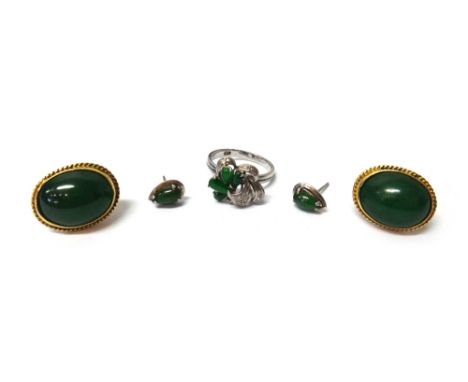 A diamond and jade ring, in an interlooped design, claw set with circular cut diamonds and with four pear shaped jade cabocho