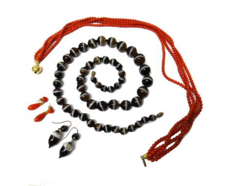 A single row necklace of graduated banded agate beads, length 65cm, with a pair of banded agate earrings, the drops carved as