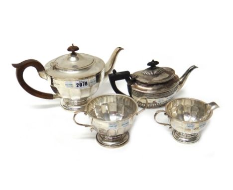 Silver, comprising; a teapot of circular form, the body with faceted decoration, with brown composition fittings, Birmingham 