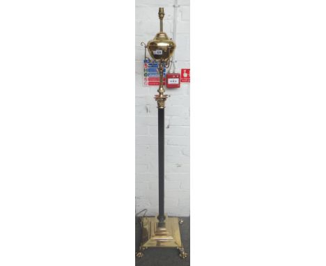 A Victorian style brass and ebonised adjustable standard lamp (converted), of Corinthian column form, with plain brass oil re