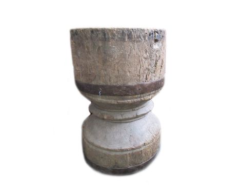 A large floor standing elm mortar, early 19th century, of waisted form with iron banded decoration and twin ring handles, 61c