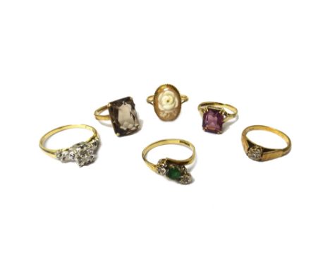 A gold and diamond set three stone ring, mounted with circular cut diamonds, detailed 14, a 9ct gold, emerald and diamond set