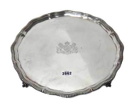 A silver salver of shaped circular form, with a pie-crust rim, having a gadrooned edge in the Chippendale style, engraved wit