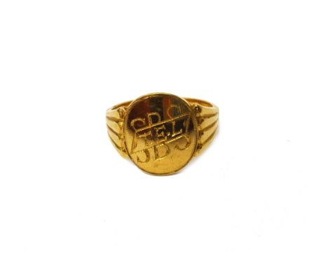 An Indian gold oval signet ring, engraved with initials, between ridged shoulders and with maker's mark K.E.W for K. EASWARA 