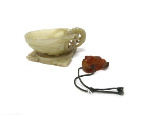 A Chinese jade brushwasher, carved and pierced with a chilong on a large gourd, 9.5cm; together with a jade pierced square pl