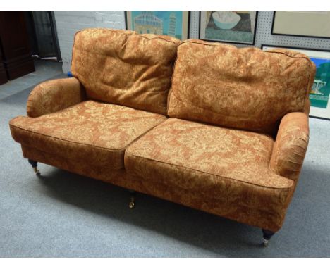 GP & J. BAKER; a 20th century sofa on three turned front supports, 183cm wide x 77cm high. 